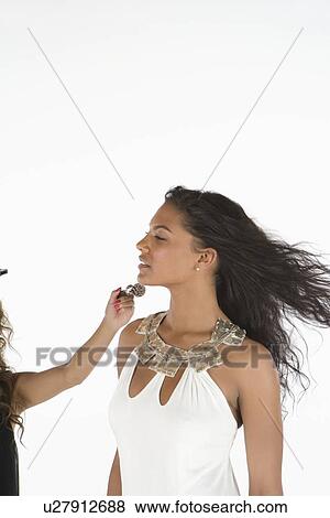 Woman in white dress has makeup applied View Large Photo Image Stock Photo - Woman in white dress has makeup applied. Fotosearch