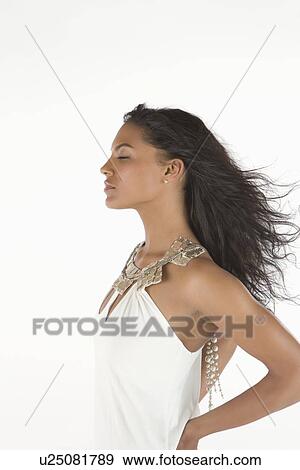 Woman in white dress stands with eyes closed View Large Photo Image Stock Photo - Woman in white dress stands with eyes closed. Fotosearch