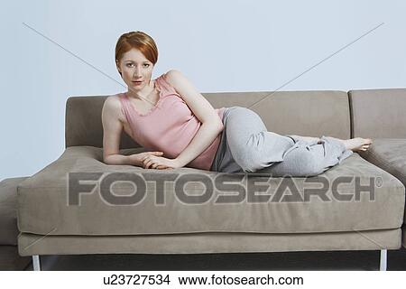 Woman lying on sofa View Large Photo Image Picture - Woman lying on sofa. Fotosearch