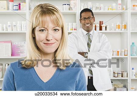 Picture - Woman picking up prescription drugs at pharmacy. Fotosearch