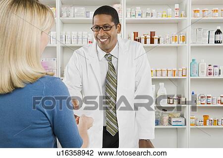 Woman picking up prescription drugs at pharmacy View Large Photo Image Stock Image - Woman picking up prescription drugs at pharmacy. Fotosearch