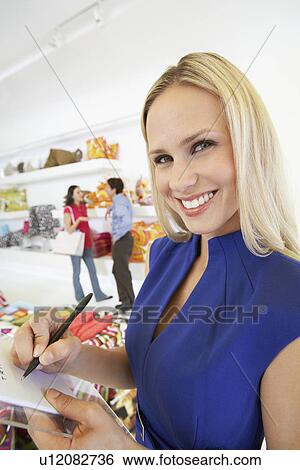 Woman Signing a Receipt View Large Photo Image Stock Photograph - Woman Signing a Receipt. Fotosearch