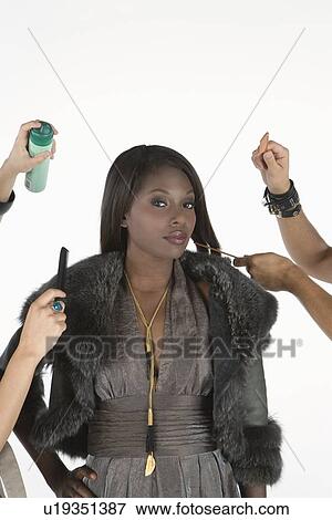 Woman stands in fur jacket with stylists on hand View Large Photo Image Stock Photo - Woman stands in fur jacket with stylists on hand. Fotosearch