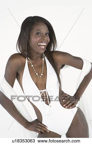 Stock Image - Woman stands in white bathing costume. Fotosearch