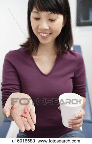 Woman taking medication in hospital View Large Photo Image Stock Image - Woman taking medication in hospital. Fotosearch