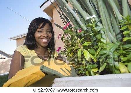 Stock Photo - Woman tending plants. Fotosearch
