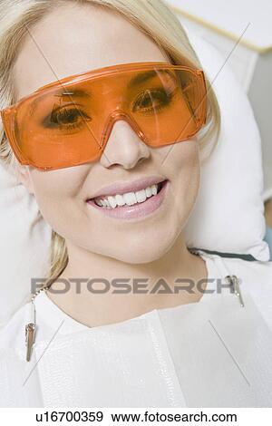 Stock Photo - Woman wearing protective glasses. Fotosearch