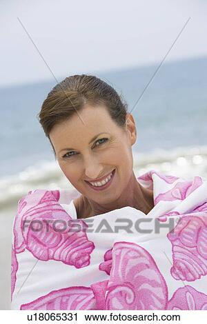 Woman wrapped in beach towel View Large Photo Image Stock Image - Woman wrapped in beach towel. Fotosearch