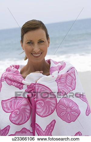 Stock Photograph - Woman wrapped in beach towel. Fotosearch