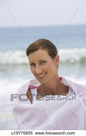 Stock Photography - Woman wrapped in beach towel. Fotosearch
