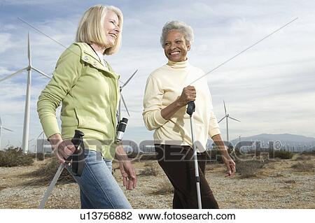 Women hiking near wind farm View Large Photo Image Stock Image - Women hiking near wind farm. Fotosearch
