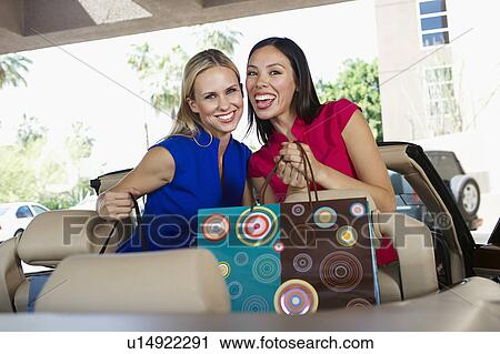 Stock Image - Women Holding Shopping Bags. Fotosearch