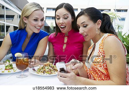 Stock Image - Women Reading a Text Message. Fotosearch