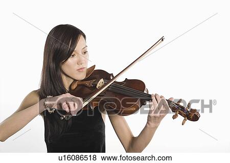 Stock Photo - Young Asian woman plays the violin. Fotosearch