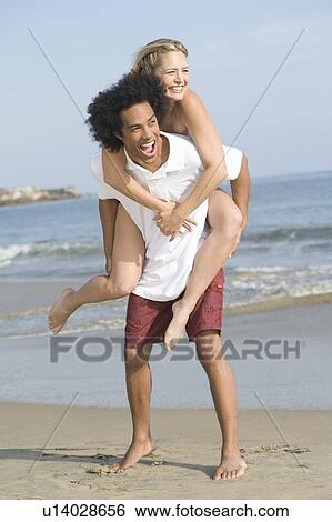 Stock Photograph - Young couple at the beach. Fotosearch