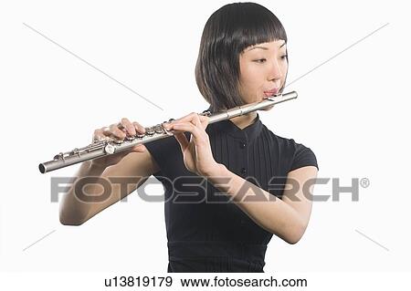 Young Korean woman playing flute View Large Photo Image Stock Photo - Young Korean woman playing flute. Fotosearch
