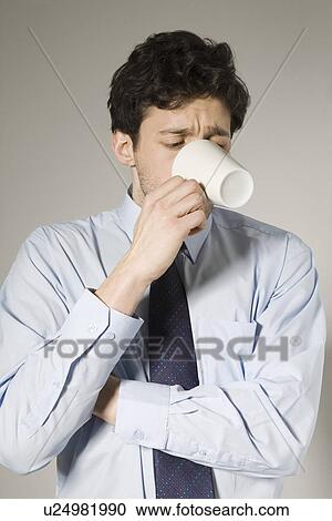 Stock Image - Young man drinking tea. Fotosearch
