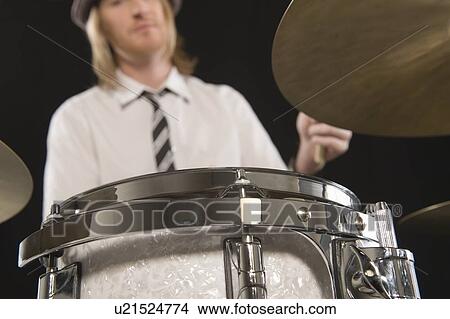 Young man plays the drums View Large Photo Image Picture - Young man plays the drums. Fotosearch