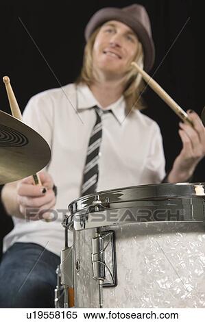 Stock Photography - Young man plays the drums. Fotosearch