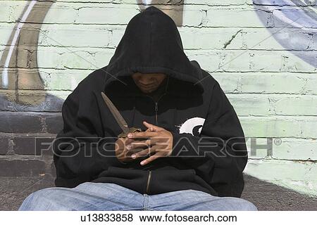 Stock Photo - Young man posing with knife. Fotosearch