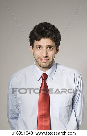 Stock Photo - Young man smiling, portrait. Fotosearch