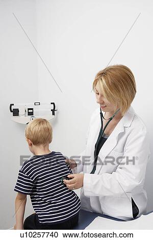 Young patient being examined View Large Photo Image Stock Image - Young patient being examined. Fotosearch