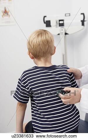 Young patient being examined View Large Photo Image Stock Image - Young patient being examined. Fotosearch