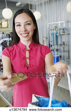 Picture - Young Woman Making a Purchase. Fotosearch