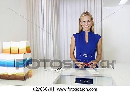 Stock Image - Young Woman Making a Purchase. Fotosearch