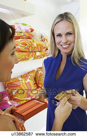 Stock Photo - Young Woman Making a Purchase. Fotosearch
