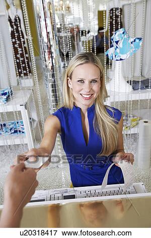 Young Woman Making a Purchase View Large Photo Image Stock Photo - Young Woman Making a Purchase. Fotosearch
