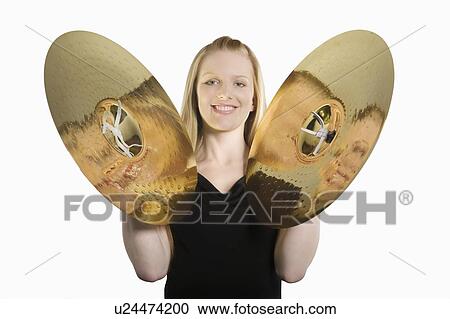 Stock Image - Young woman plays the cymbals. Fotosearch