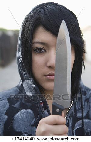 Young woman posing with knife View Large Photo Image Stock Image - Young woman posing with knife. Fotosearch