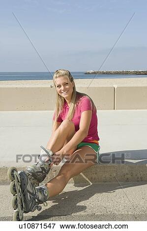Young woman wearing rollerblades View Large Photo Image Stock Photo - Young woman wearing rollerblades. Fotosearch
