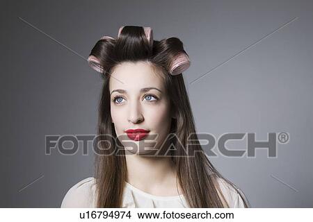 Young woman with hair curlers and red lipstick View Large Photo Image Picture - Young woman with hair curlers and red lipstick. Fotosearch