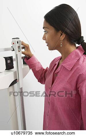 Young woman with scales View Large Photo Image Stock Photography - Young woman with scales. Fotosearch