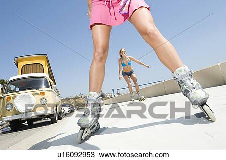 Young women on rollerblades View Large Photo Image Stock Image - Young women on rollerblades. Fotosearch