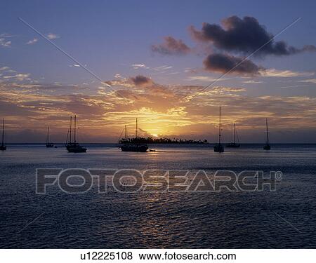 Stock Photo - Sunset of Moorea Island, Tahiti. Fotosearch