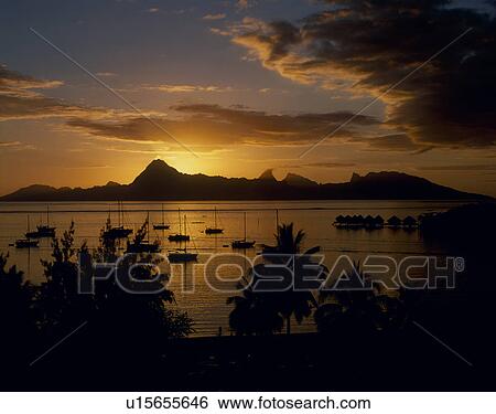 Stock Photograph - Sunset of Moorea Island, Tahiti. Fotosearch
