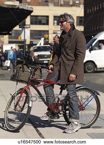 Adult man on a bicycle in Manhattan, New York City, U. S. A. View Large Photo Image Stock Image - Adult man on a bicycle in Manhattan, New York City, U. S. A.. Fotosearch