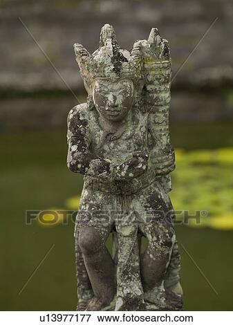 Stock Photo - Ancient statue in Bali. Fotosearch