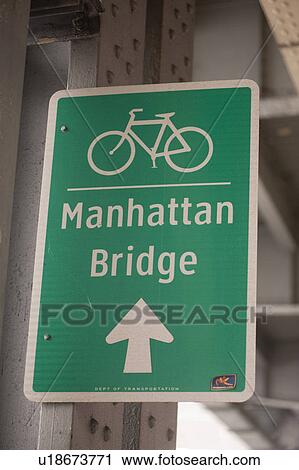 Stock Image - Bicycle lane direction sign to the Manhattan Bridge in Manhattan, New York City, U. S. A.. Fotosearch