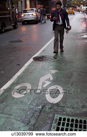 Stock Photo - Biking lane symbol in Manhattan, New York City, U. S. A.. Fotosearch