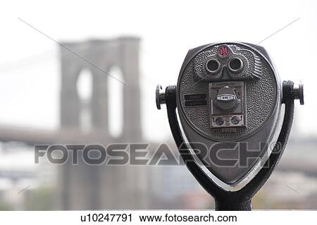 Stock Image - Binoculars on riverbank in Manhattan, New York City, U. S. A.. Fotosearch