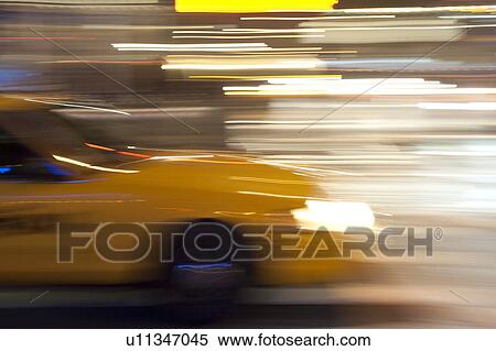 Blurred image of a yellow taxi in Manhattan, New York City, U. S. A. View Large Photo Image Stock Photography - Blurred image of a yellow taxi in Manhattan, New York City, U. S. A.. Fotosearch