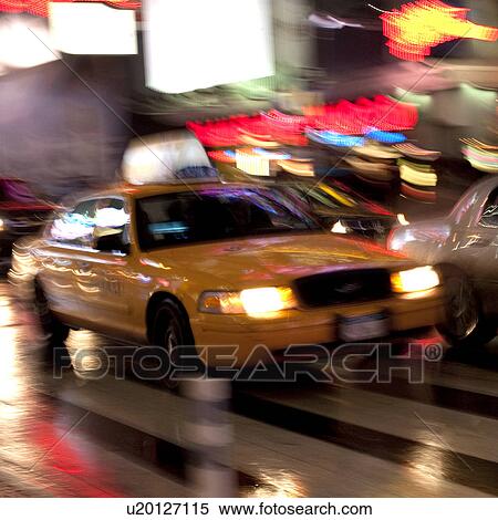 Stock Photography - Blurred view of a taxi in Manhattan, New York City, U. S. A.. Fotosearch
