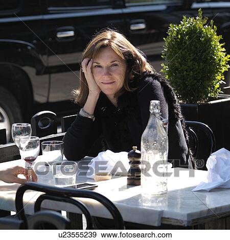 Stock Photo - Brunette woman at a outdoor cafe in Manhattan, New York City, U. S. A.. Fotosearch