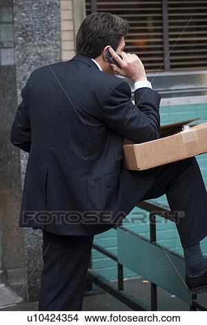 Picture - Businessman talking on his cell phone in Manhattan, New York City, U. S. A.. Fotosearch