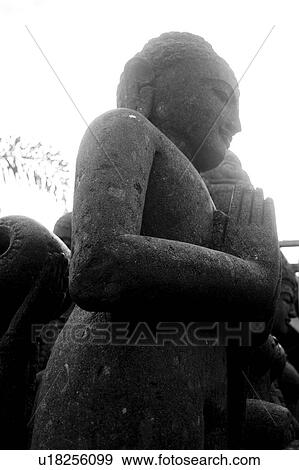 Stock Photo - Carved Buddha statue in Bali. Fotosearch