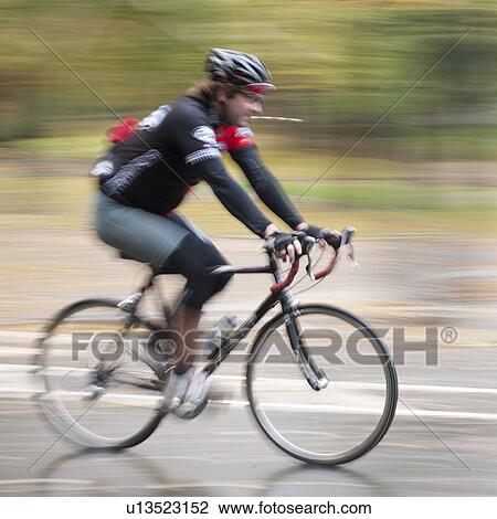Stock Image - Cyclist in Manhattan, New York City, U. S. A.. Fotosearch
